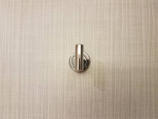 istock metalic metal coat hook or fixture on grey wall 1440873640