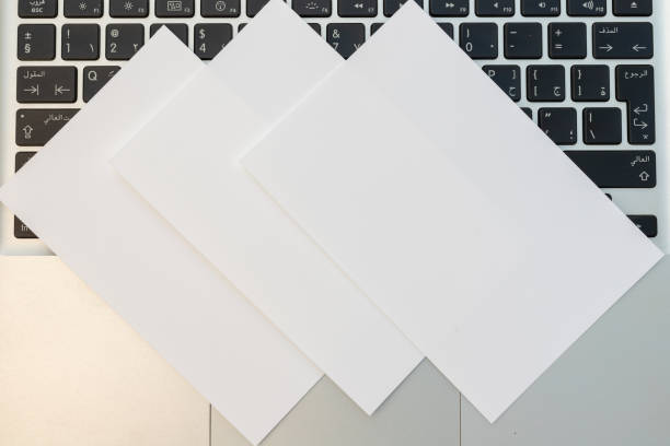 istock Three white blank business cards over a laptop 1440874317