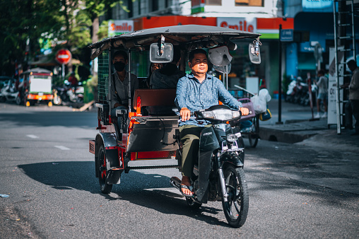 Cambodia, Phnom Penh, November 11, 2022. Tuk-tuk on the road, in the city of Phnom Penh.