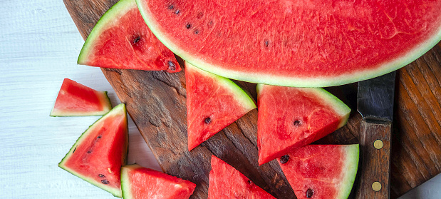 Close up of tasty sliced fresh watermelon on a wooden chopping board