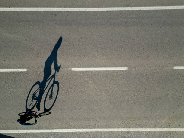 istock cyclist and his shadow on the highway 1440879495
