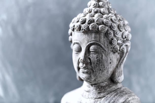 istock Meditating Buddha Statue on bright background. Close up. 1440882904