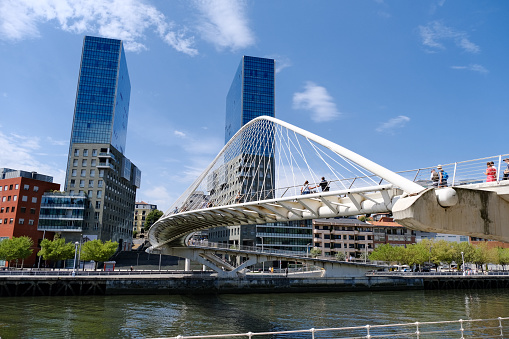 The Isozaki Atea twin towers and futuristic Zubizuri pedestrian bridge in Bilbao, Spain. The towers are the tallest residential buildings in the city and the Basque Country, 83 metres tall.