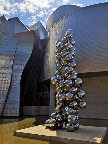 Illusionistic work and exterior view, clad in glass, titanium, and limestone of the famous Guggenheim Museum, a museum of modern and contemporary art designed by Canadian-American architect Frank Gehry, in Bilbao, Basque Country, Spain. It is one of the largest museums in Spain.