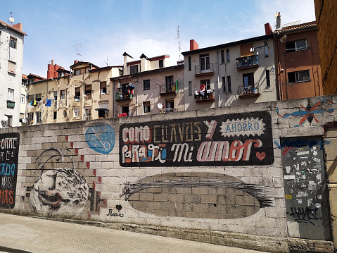 Old fashioned residential buildings over graffiti wall in the San Francisco neighborhood of Bilbao, the largest city in the Basque Country, on the north coast of Spain.