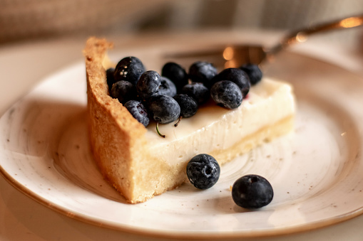 Vegan cheesecake with blueberries in a cafe, close-up.Healthy eating and healthy lifestyle.Vegetarian and vegan diet.Veganuary concept.
