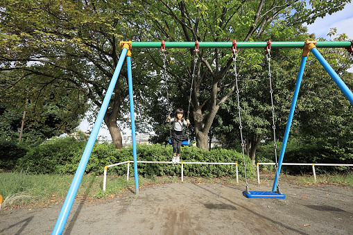 Japanese student girl on the swing (8 years old)
