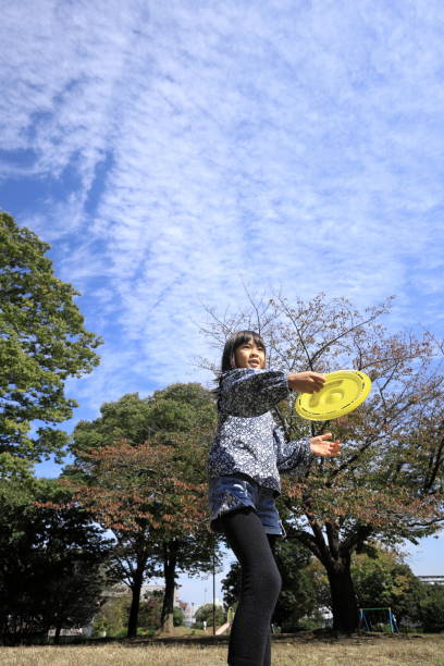 istock Japanese student girl playing flying disc (8 years old) 1440902021