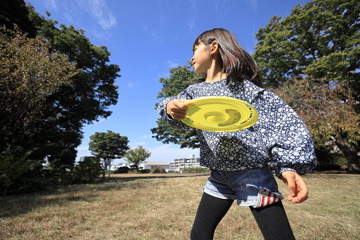 Japanese student girl playing flying disc (8 years old)