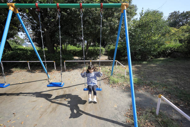 istock Japanese student girl on the swing (8 years old) 1440902582