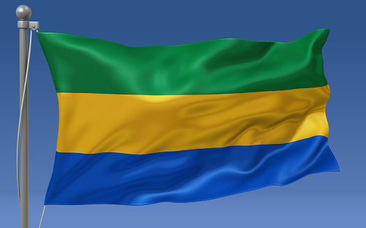 Gabon flag waving on the flagpole on a sky background