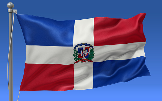 Dominican Republic flag waving on the flagpole on a sky background