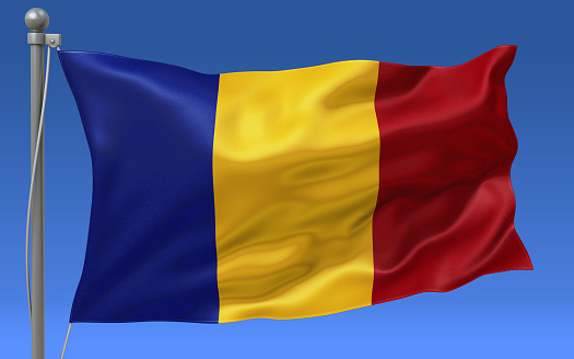 Chad flag waving on the flagpole on a sky background