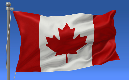 Canada flag waving on the flagpole on a sky background