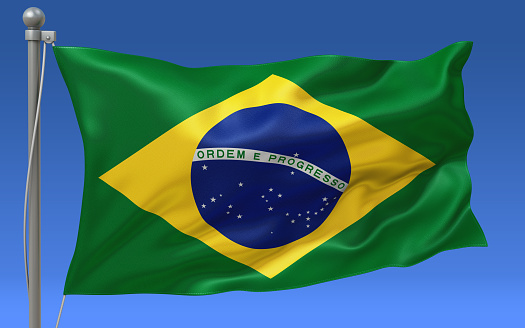 Brazil flag waving on the flagpole on a sky background