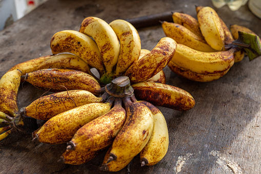 Photo of a bunch of riped homegrown organic fresh bananas displaying on a table after being prepared for selling