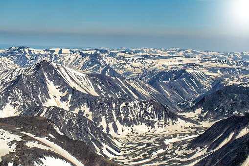 Northern landscape. The mountains are covered with glaciers. View from helicopter flight altitude