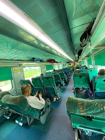 Bijnor, Uttar Pradesh, India - September 4, 2022: Stock photo showing the interior view of an Indian railway carriage with open overhead baggage compartment.