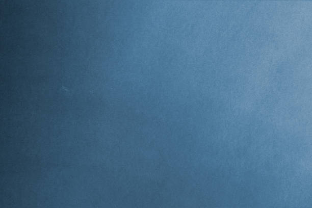 istock Blue paper texture background with some small white spots and dirt. 1440909657