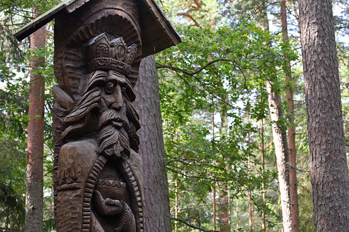 Juodkrante, Lithuania - August 24, 2022: Old wooden sculptures in the forest. Witch Hill park in Juodkrante, Lithuania. The Hill of Witches is an outdoor sculpture gallery.