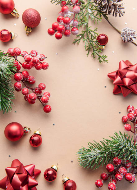 istock Bright Christmas frame of spruce, red  christmas decorations on beige  background. 1440912626