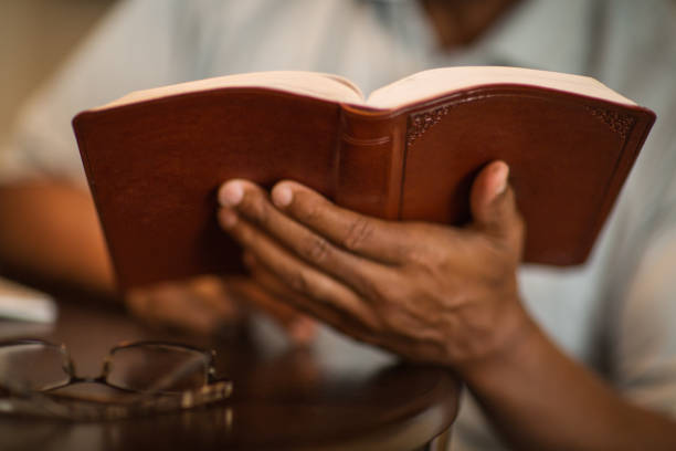 istock African American man praying and reading the Bible. 1440914264