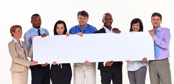 Group of a business people are holding a big paper for commercials. They are isolated on white background. Diverse ethnicity.