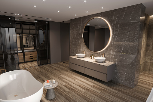 Modern bathroom hotel room interior with closet. Big round mirror, marble wall, sink, bathtub and shower cabins in the background. Render.