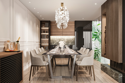 Luxury dining room interior. Dining table, chairs, parquet, plates, pendant lamp, LED light, decoration, white wall, plant and kitchen in the background. Template for copy space. Render.