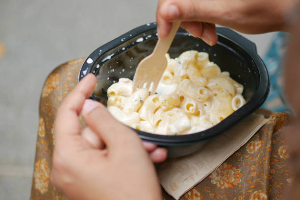 istock women eating take away cooked pasta in a plastic container 1440918998