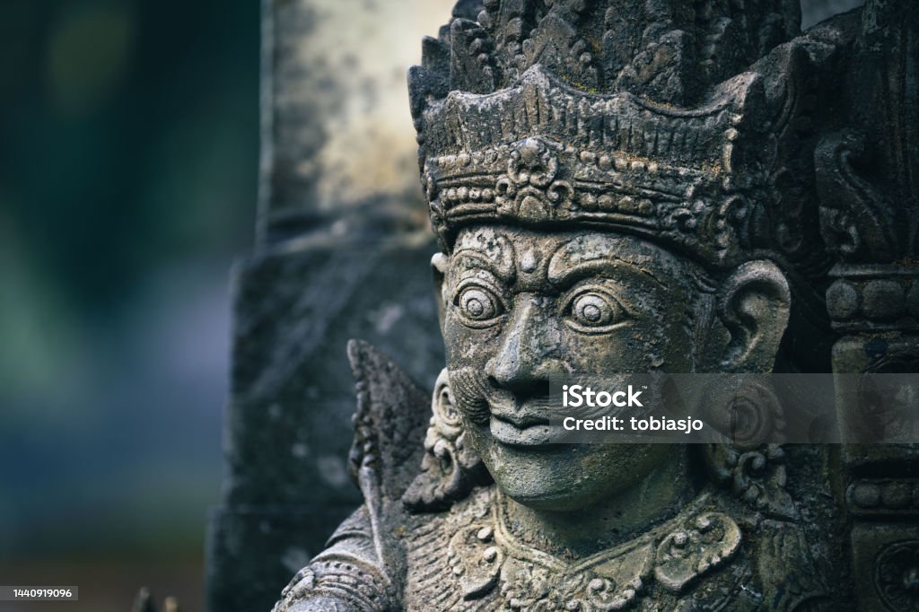 Traditional sculpture made of stone in Bali Traditional sculpture made of stone seen in the jungle of the Bali island, Indonesia. God Stock Photo