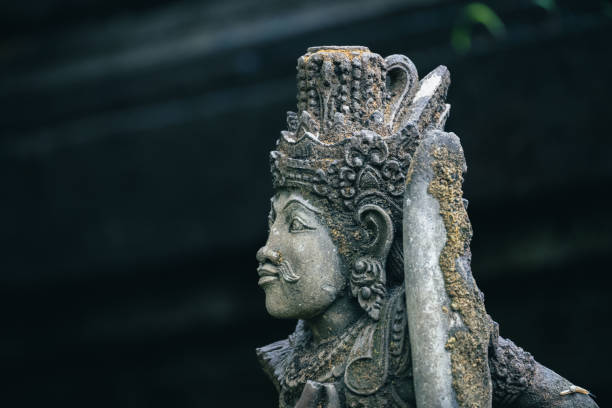 Traditional sculpture made of stone seen in the jungle of the Bali island, Indonesia.