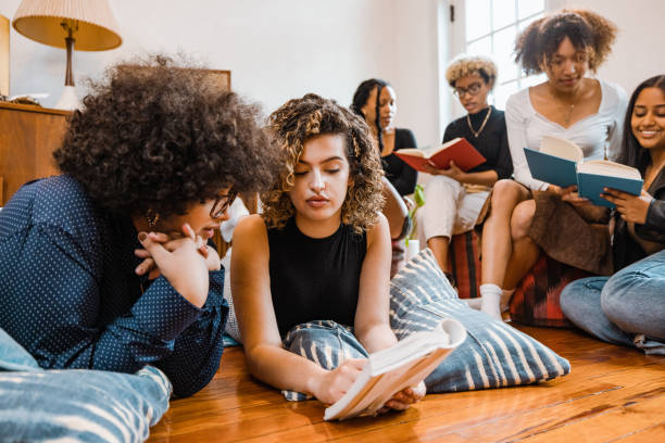 istock Book club, group of young students reading together 1440919312