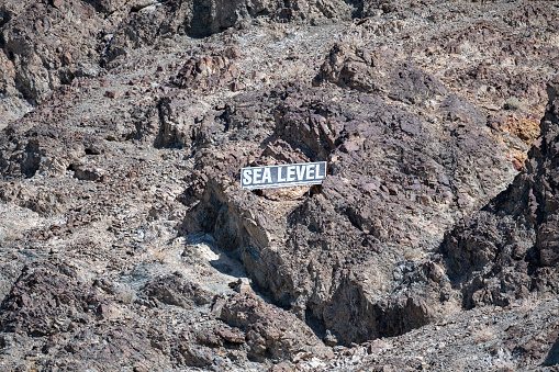 Sea level sign at the Badwater Basin at Death Valley National Park, California, USA. The lowest point on earth seen a hot summer day.