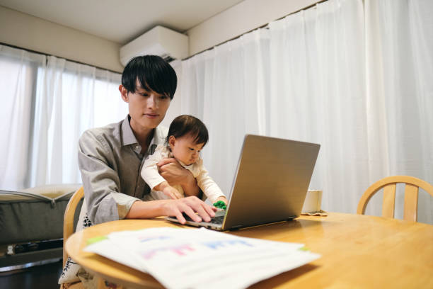 istock Father working from home with baby 1440919376