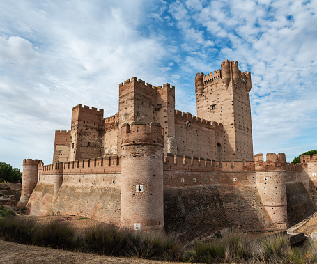 Medina del Campo, Spain - October 16, 2022: Wide-angle view of the famous castle Castillo de la Mota in Medina del Campo, Valladolid. This reconstructed medieval fortress, started in 1080, is currently declared as Spanish Heritage of Cultural Interest, being one of he best preserved in Spain.