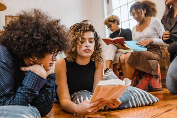 istock Book club, group of young students reading together 1440920283