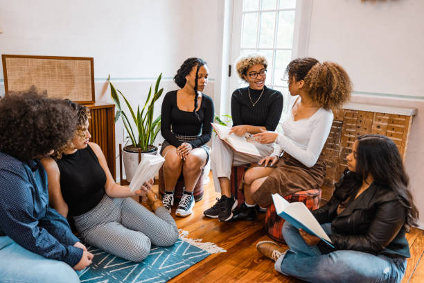 istock Book club, group of young students reading together 1440920461