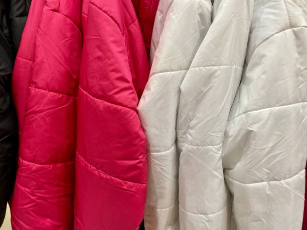 istock Suspended coats and raincoats in the store 1440920627