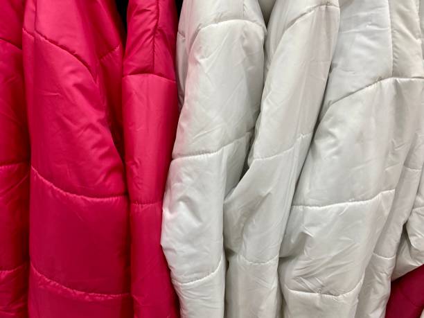 istock Suspended coats and raincoats in the store 1440920659