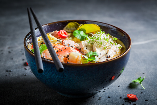 Yummy Malaysian Soup made of coconut milk and shrimps. Classic Malaysian soup with vegetables and meat.