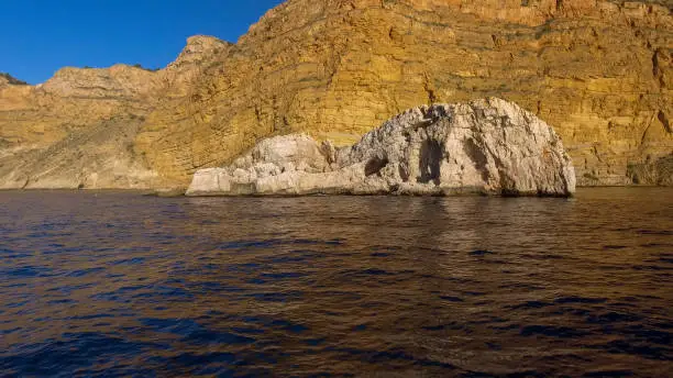 Sierra Helada cliffs and Mitjana island from the sea, Benidorm, Alicante province, Spain
