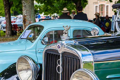 Baden-Baden, Germany - 14 July 2019: logo emblem symbol sign of dark green Stoewer G15K cabrio roadster 1929 which is parked in Kurpark in Baden-Baden at the exhibition of old cars \