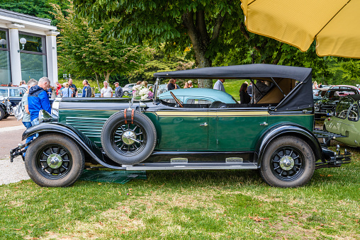 Baden-Baden, Germany - 14 July 2019: dark green Stoewer G15K cabrio roadster 1929 is parked in Kurpark in Baden-Baden at the exhibition of old cars \