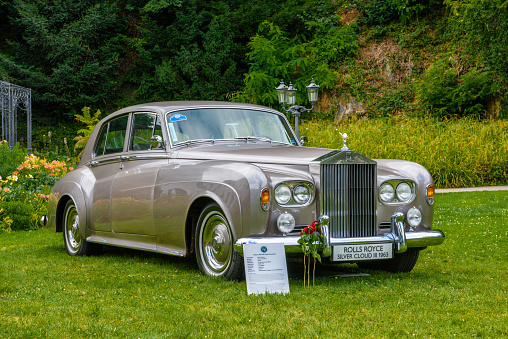 Baden-Baden, Germany - 14 July 2019: silver sand gray metallic Rolls-Royce Silver Cloud 3 III sedan limousine 1963 1955 1966 is parked in Kurpark in Baden-Baden at the exhibition of old cars \