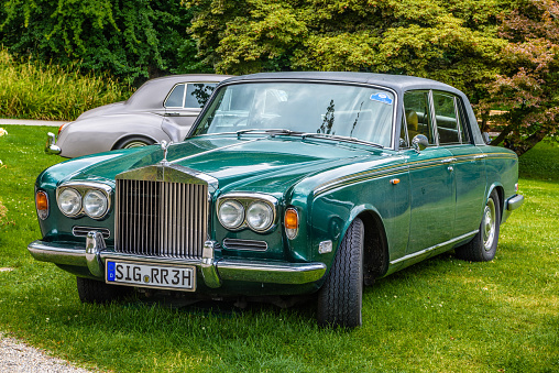Baden-Baden, Germany - 14 July 2019: green Rolls-Royce Silver Shadow cabrio 1965 1980 is parked in Kurpark in Baden-Baden at the exhibition of old cars \