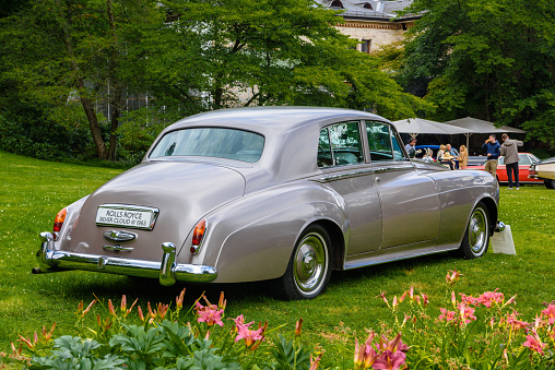 Baden-Baden, Germany - 14 July 2019: silver sand gray metallic Rolls-Royce Silver Cloud 3 III sedan limousine 1963 1955 1966 is parked in Kurpark in Baden-Baden at the exhibition of old cars \