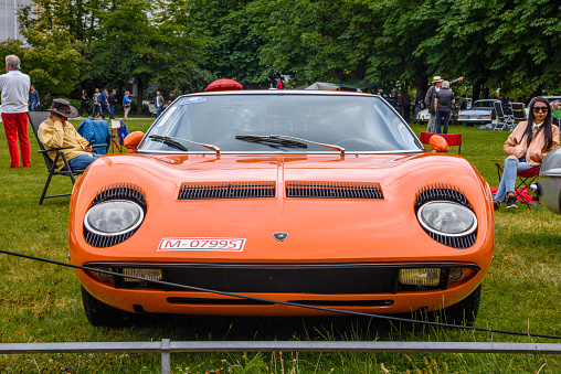 Baden-Baden, Germany - 14 July 2019: orange Lamborghini Miura P400 sport car coupe 1966 1973 is parked in Kurpark in Baden-Baden at the exhibition of old cars \