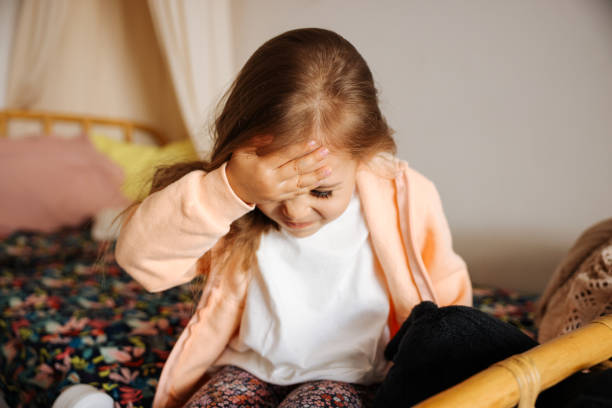 istock Headache and child feeling sick in bed 1440925863