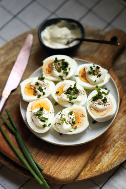 istock Boiled egg halves with mayonnaise and green onions. 1440926691